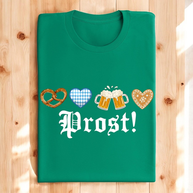 A green t-shirt with a graphic design featuring beer mugs, pretzels, hearts, and the word "Prost!"