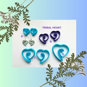 Peut inclure: Boucles d'oreilles et pendentifs Tribal Heart en bleu et violet. Les boucles d'oreilles sont une paire de cœurs bleus avec un motif en spirale. Les pendentifs sont une paire de cœurs bleus avec un motif en spirale et une paire de cœurs violets avec un motif en spirale. Les pendentifs sont étiquetés A, B, C et D.
