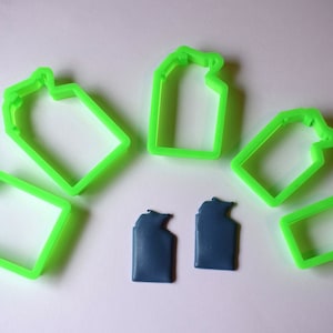 May include: A set of six green plastic cookie cutters shaped like milk cartons. Two blue plastic milk cartons are also included.