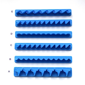 May include: Five blue plastic cake decorating tools with different wavy edge designs. The tools are labeled A through E.