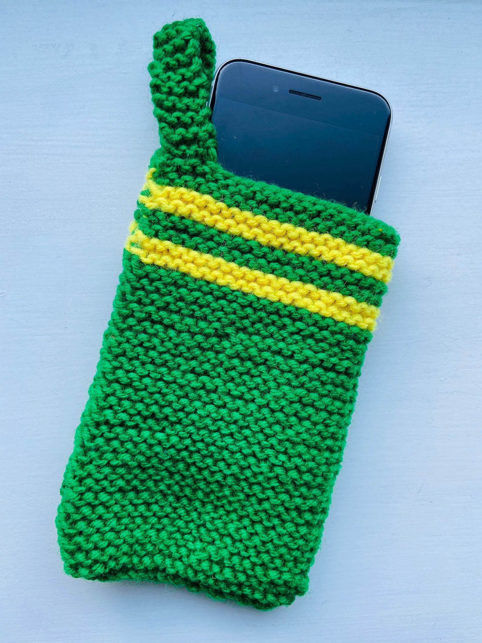 Handknitted mobile phone case. All proceeds of sale donated Etsy
