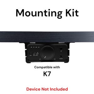 May include: A black mounting kit for a K7 device. The kit is shown mounted to a black surface. The text "Mounting Kit" is at the top of the image. The text "Compatible with K7" is below the kit. The text "Device Not Included" is at the bottom of the image.