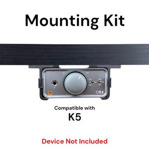 May include: A black mounting kit for a silver audio interface. The kit is compatible with the K5 device. The text "Device Not Included" is printed below the image.