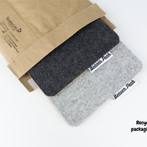 Our recyclable mailers being shown with a phone mat being removed from the mailer.