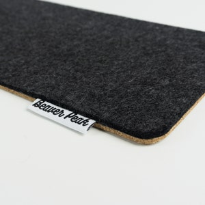 Close up of felt and cork keyboard mat made with black merino wool and showing BeaverPeak logo.