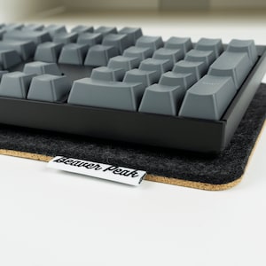 Mechanical keyboard on top of black felt desk mat -full size Keychron K10 keyboard.