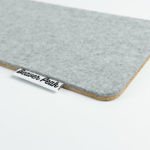 Close up of wool and cork keyboard mat made with grey merino wool and showing BeaverPeak logo.