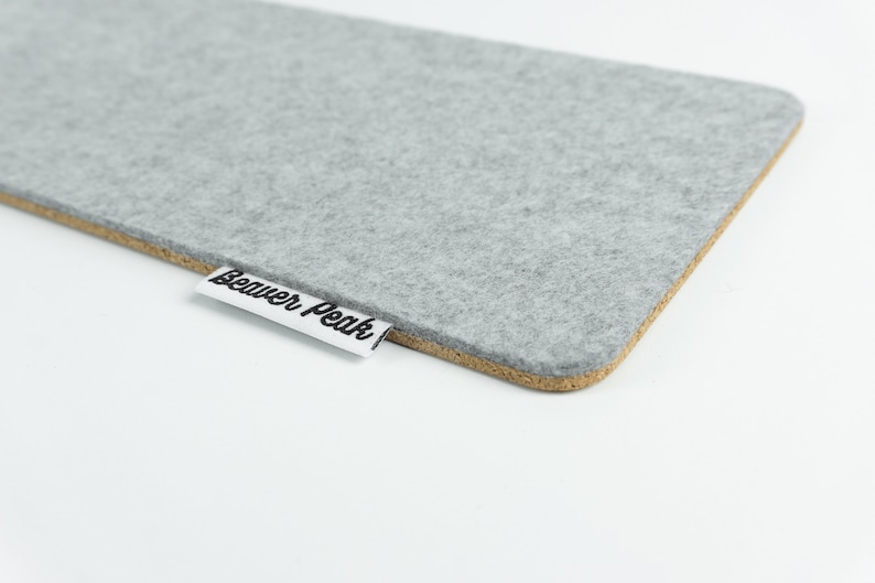 Close up of wool and cork keyboard mat made with grey merino wool and showing BeaverPeak logo.