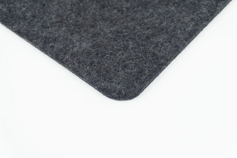 A closeup of our black merino wool felt that we use to make our phone pads.