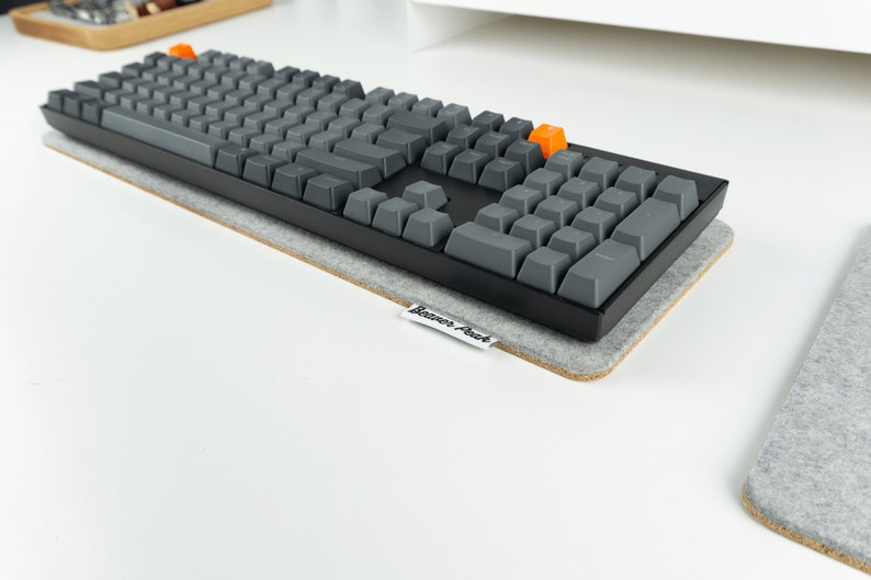 Keychron K10 mechanical keyboard on grey felt sound dampening keyboard mat.