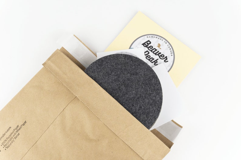Recyclable packaging for our wool coasters shown up close. We ship each set of coasters out in a recycled paper mailer.