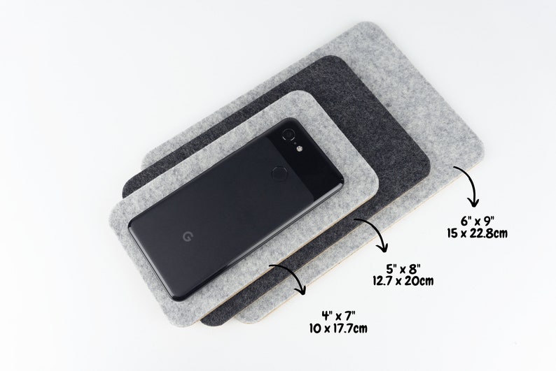 Size comparison of our wool felt phone mats. Three sizes of phone mats are shown: small 4 x 7 inches (10 x 17.7 cm), medium 5 x 8 inches (12.7 x 20cm), large 6 x 9 inches (15 x 22.8 cm).