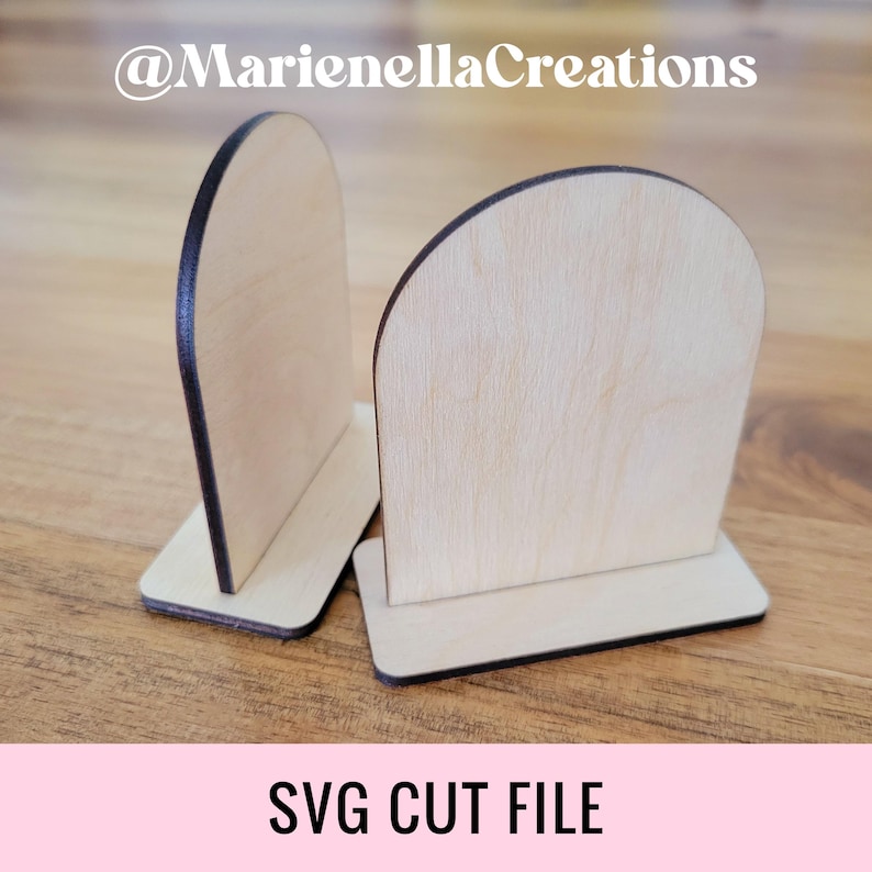 May include: Two unfinished wooden signs with rounded tops and a flat base. The signs are made of light wood and have a dark brown border. The signs are perfect for crafting and personalization.  @MarienellaCreations SVG CUT FILE