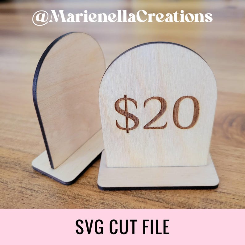 May include: Two wooden price tag stands with a rounded top. The stand on the right has the price $20 engraved on it.  SVG cut file.