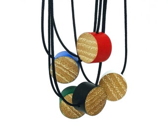 Necklace with a circular bead in wood and a coloured edge