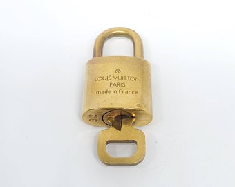 Repurposed vintage brass Louis Vuitton padlock 311 with layered