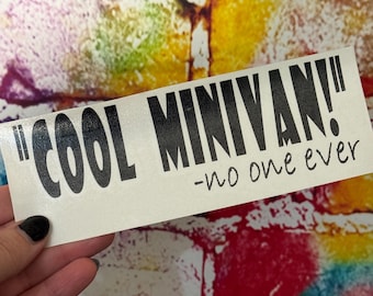 May include: A white rectangular sticker with the text "COOL MINIVAN!" in bold black letters, followed by "-no one ever" in a smaller font. The sticker is held against a colorful, textured background.