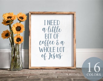 May include: A framed canvas sign with the text "I need a little bit of coffee & a whole lot of Jesus" in blue lettering on a white background. The sign is framed in wood with a rustic finish. The sign is sitting on a brick surface with a vase of sunflowers in the foreground.