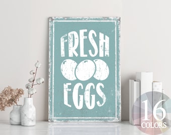 May include: A blue and white sign with the text "FRESH EGGS" in white lettering. The sign has a distressed look and three white eggs are depicted in the center.