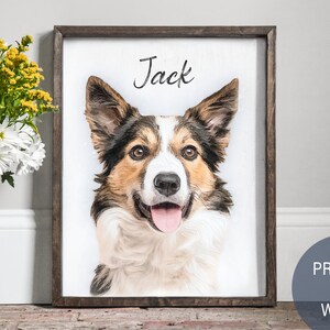 Pode incluir: Uma impress&atilde;o emoldurada de um retrato de c&atilde;o em madeira. O c&atilde;o &eacute; um border collie marrom e branco com o nariz preto e a l&iacute;ngua para fora. O nome do c&atilde;o, "Jack", est&aacute; escrito em it&aacute;lico acima do retrato.