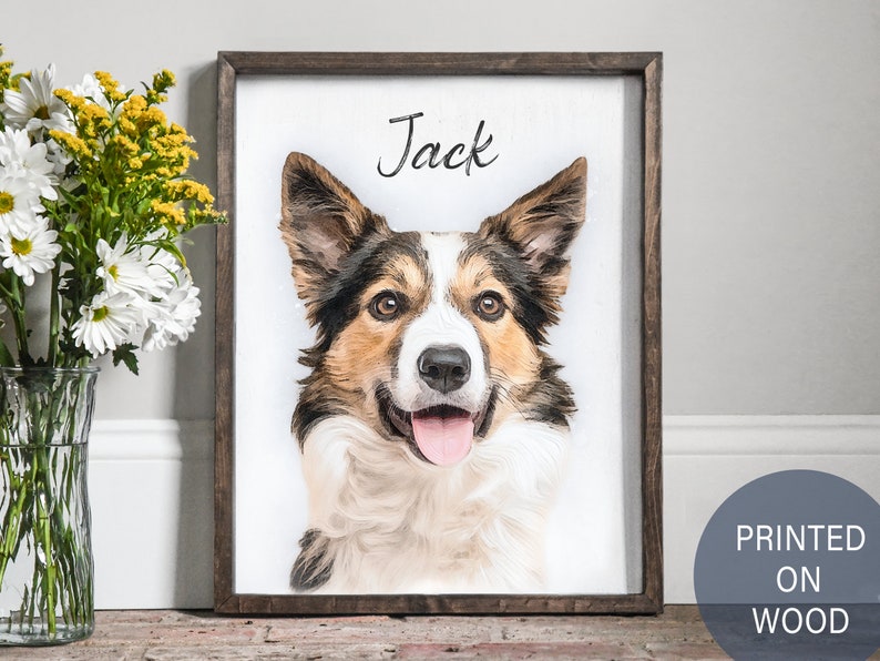Pode incluir: Uma impress&atilde;o emoldurada de um retrato de c&atilde;o em madeira. O c&atilde;o &eacute; um border collie marrom e branco com o nariz preto e a l&iacute;ngua para fora. O nome do c&atilde;o, "Jack", est&aacute; escrito em it&aacute;lico acima do retrato.