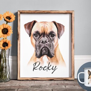 Pode incluir: Um retrato em aquarela emoldurado de um c&atilde;o Boxer chamado "Rocky" com pelagem marrom e castanho. Uma caneca de esmalte branco com um retrato de um c&atilde;o chamado "Charlie" tamb&eacute;m &eacute; vis&iacute;vel. Um vaso de vidro transparente cont&eacute;m girass&oacute;is amarelos.