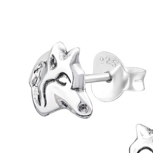 May include: Sterling silver wolf head stud earrings. The earrings are small and delicate, with a detailed wolf head design. The earrings are marked "925" on the back.