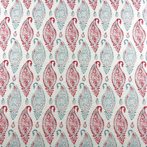 May include: A cream-coloured fabric featuring a repeating paisley pattern in red and teal blue. The paisley motifs are filled with detailed designs, creating a visually rich textile.