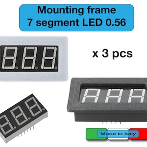 May include: Three 0.56 inch, 7-segment LED displays with a black face and white digits, mounted in a black plastic frame. The frame has a textured surface. The text "Made in Italy" is visible below the frame.