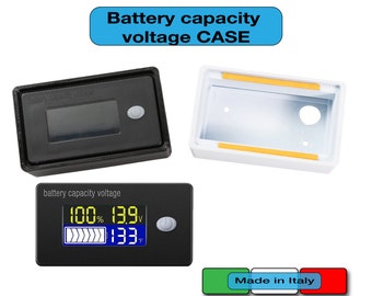 May include: Black battery capacity voltage monitor with a digital display showing 100% and 13.9V. The monitor also shows a temperature reading of 133 degrees. The monitor is in a white plastic case with a small button on the side.