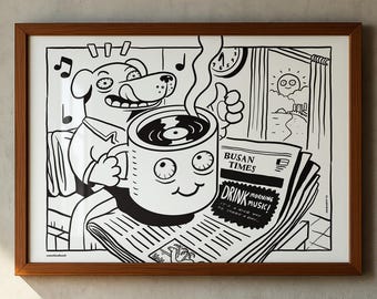May include: A framed black and white line art print featuring a cartoon dog holding a mug with a vinyl record inside. The dog sits next to a newspaper titled Busan Times with the text Drink Morning Music. A sun and ocean scene is visible in the background.