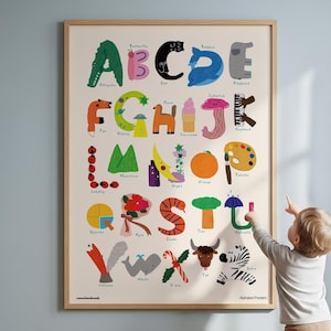 May include: A rectangular wall poster featuring a colorful illustrated alphabet where each letter is represented by a corresponding object or animal, such as an alligator for A, a cat for C, and a zebra for Z, all set against a light cream background.