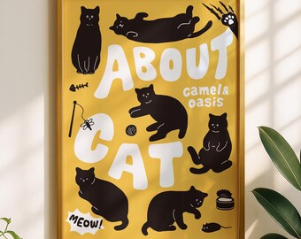 May include: A framed yellow poster featuring black cat illustrations and the white text ABOUT CAT, camel & oasis, and MEOW!. The design includes various cat-related icons like a fish skeleton, a yarn ball, a toy, a mouse, and a food can.