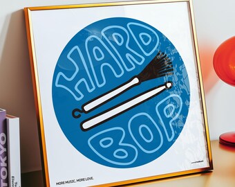 May include: A square framed print featuring a blue circle with the white text "HARD BOP" and an illustration of two drumsticks. The print includes the text "MORE MUSIC, MORE LOVE." at the bottom left corner, all encased in a thin gold frame.