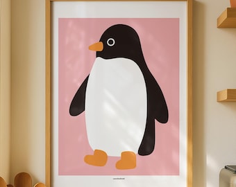 May include: A framed wall art print featuring a stylized illustration of a penguin with a black body, white chest, and orange beak and feet, set against a solid pink background. The artwork is enclosed in a light-colored wooden frame.