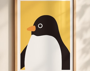 May include: A framed wall art print featuring a stylized graphic illustration of a penguin with a black head and back, a white chest, and an orange beak, set against a solid yellow background. The print is encased in a light wood frame.