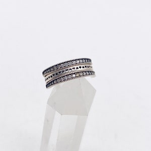 May include: A silver ring with two rows of small, clear stones set in a delicate design.