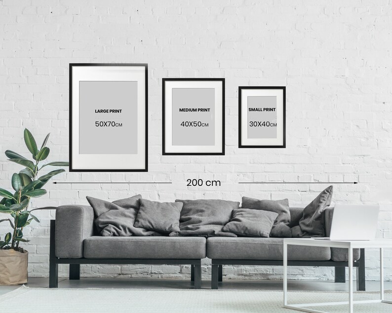 May include: Three black framed prints with white mats and text. The prints are labeled "Large Print 50x70cm", "Medium Print 40x50cm", and "Small Print 30x40cm". A measuring tape shows the distance between the two outer frames is 200 cm.