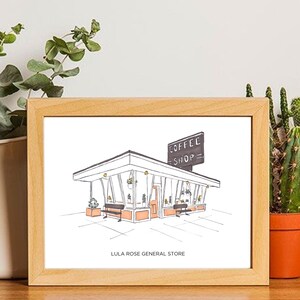May include: A framed illustration of a small building with a sign that reads "COFFEE SHOP" and the text "LULA ROSE GENERAL STORE" below the building.