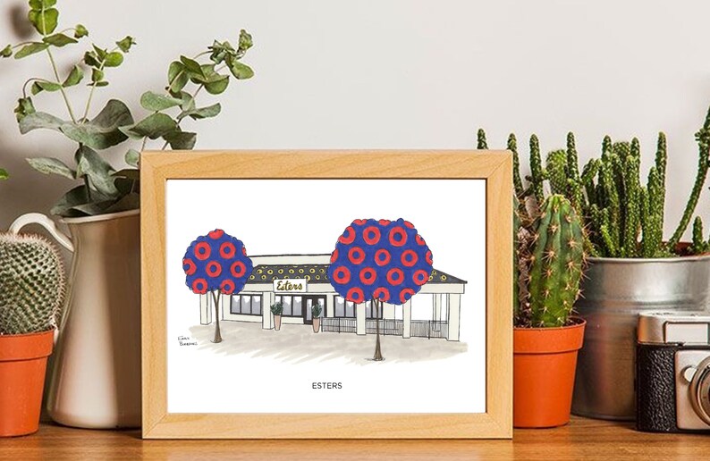 May include: A framed illustration of a building with a blue roof and white trim. The building has a sign that says "Esters". There are two trees with red and blue donut patterns on them. The illustration is titled "Esters" at the bottom.