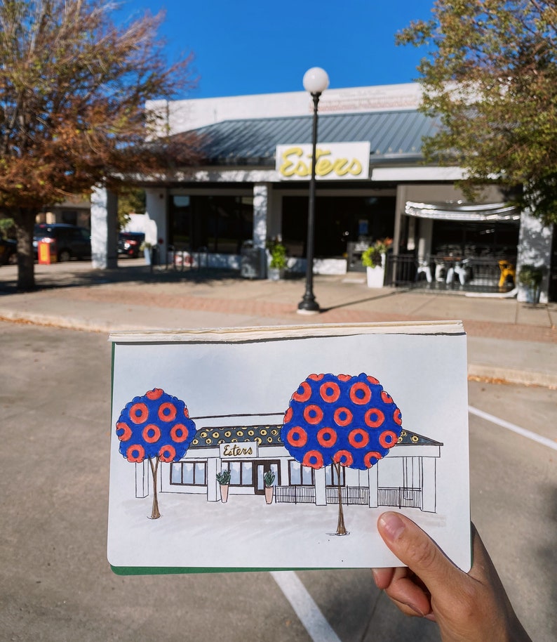 May include: Hand-drawn illustration of a building with the word "Esters" above the entrance. The building has two large trees with blue and red donut-shaped leaves. The trees are in front of the building.