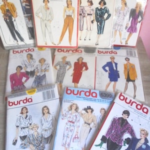 May include: A collection of vintage Burda sewing pattern envelopes. The patterns feature illustrations of women in various outfits, including suits, dresses, and blouses. The envelopes display the Burda logo and pattern numbers.