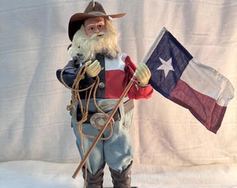 Botas de vaquero del oeste con gorro de Papá Noel, bandera y cuerda. (Tiene una grieta en la cabeza y un desgarro en el gorro, como se muestra en la foto).