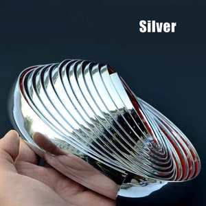 May include: Silver trim molding for cars. The molding is flexible and comes in a roll. It is designed to protect the edges of your car from scratches and dents.
