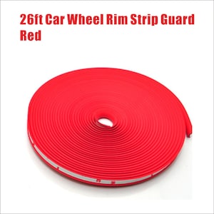 May include: A roll of bright red car wheel rim strip guard. The text "26ft Car Wheel Rim Strip Guard Red" is displayed at the top of the image. The guard is a flexible strip designed to protect car wheels.