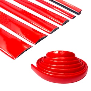 May include: Red trim molding for cars, shown in a coiled roll and as individual strips. The trim is flexible and can be used to cover edges and gaps.