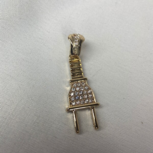 Plug Charm, with rhinestone accents.  Gold in color.