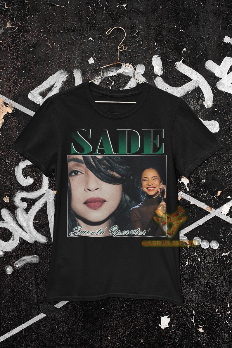 May include: Black t-shirt with a green and white graphic of Sade with the text "SADE" and "Smooth Operator".