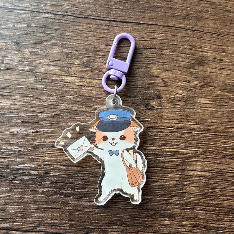 May include: A clear acrylic keyring featuring a cartoon dog dressed as a mail carrier. The dog wears a blue hat and bow tie, holding an envelope with a heart. A purple clasp is attached.