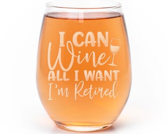 May include: A stemless wine glass filled with amber liquid, featuring the etched white text I CAN Wine ALL I WANT I'm Retired and a small graphic of a wine glass. The glass has a rounded bowl shape and a clear, smooth glass construction.